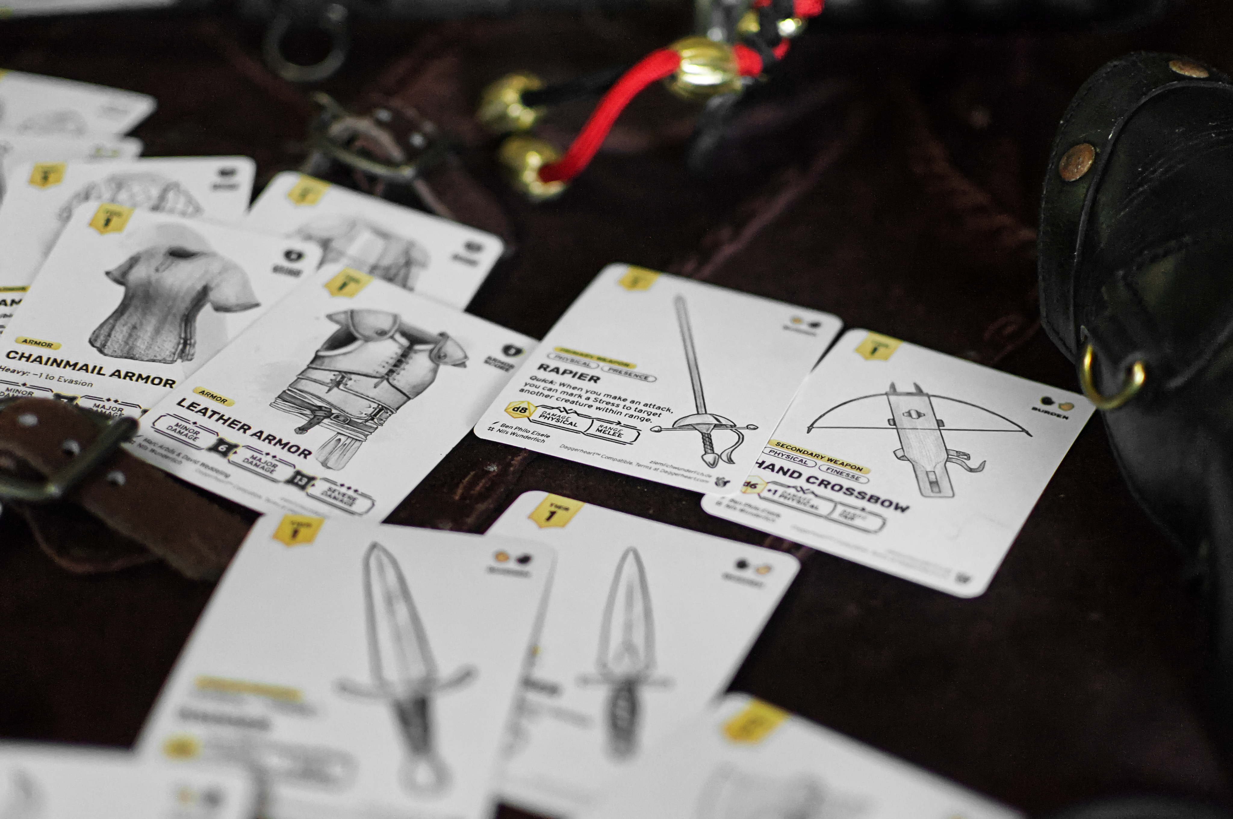 Heart of daggers logo and mood image of equipment cards